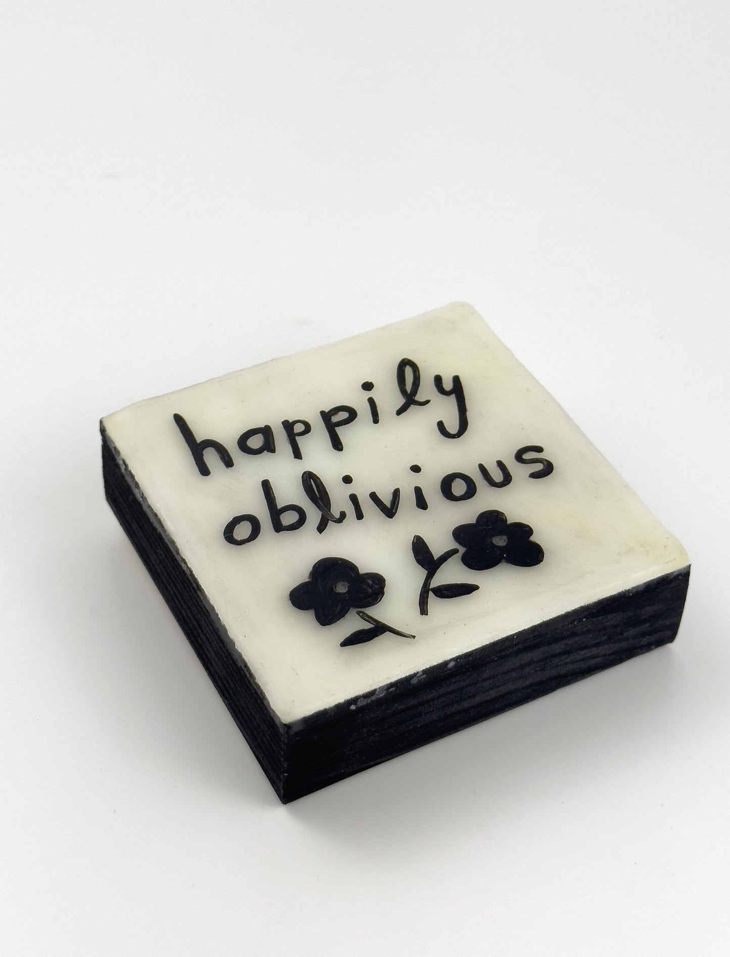 Original painting with 'happily oblivious' text and floral design on a white background