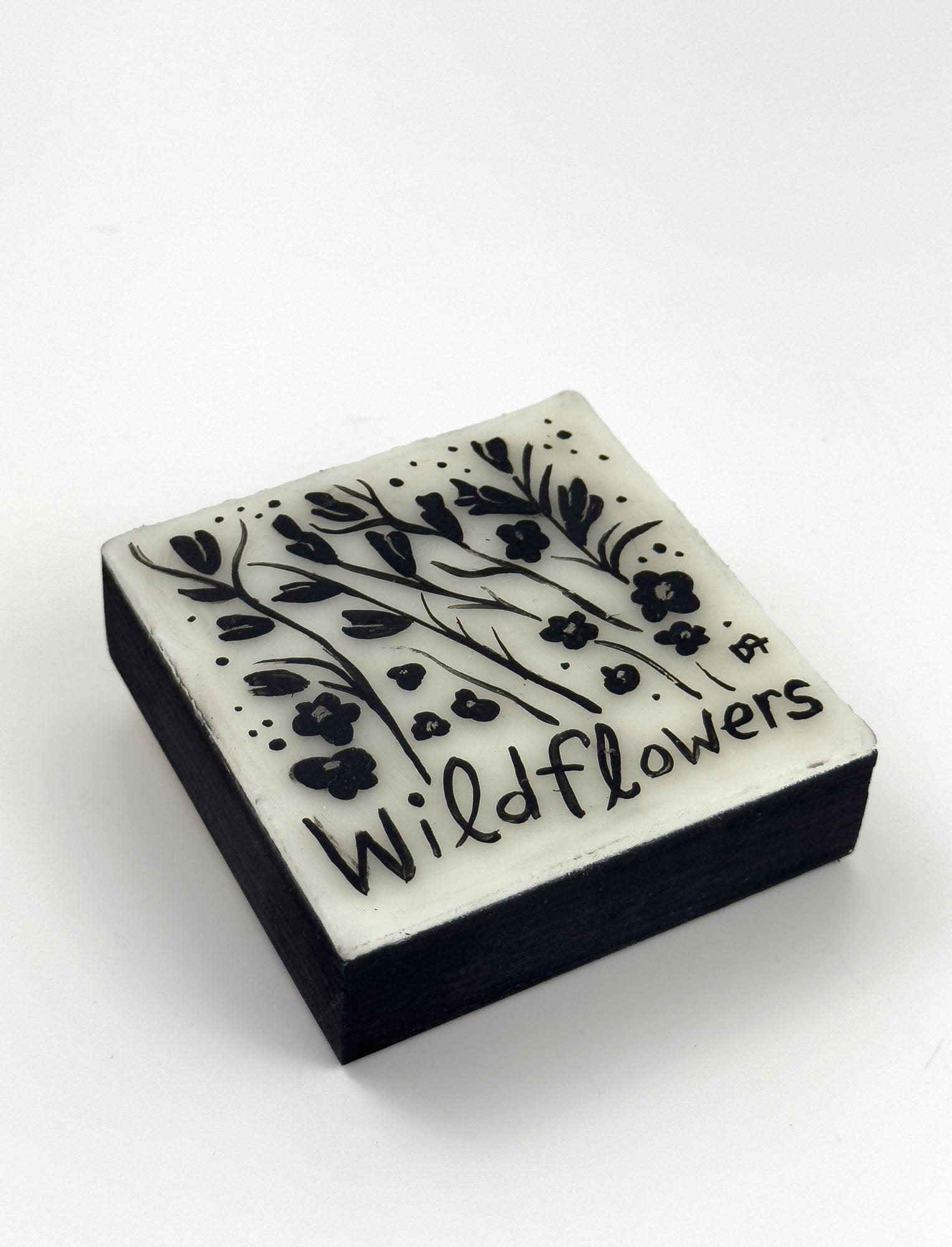 Original painting black floral design and 'Wildflowers' text on a white background